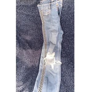 mom jeans only have a hole in each knee, and has checkered stripes on the side